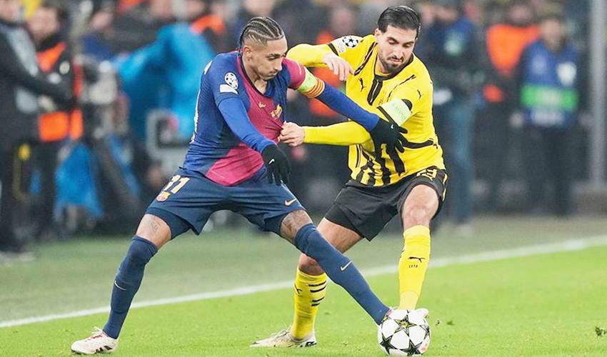 Raphinha dikawal Emre Can di laga Borussia Dortmund vs Barcelona, Liga Champions 2024/2025 (c) AP Photo/Martin Meissner